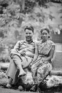 Portrait of happy friends sitting outdoors