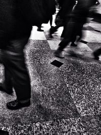 Low section of people walking on road