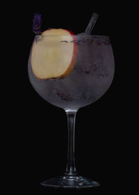 Close-up of beer glass against black background