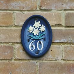 Close-up of flower on brick wall