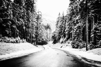 Road passing through snow covered landscape