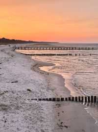 Scenic view of beach against sky during sunset