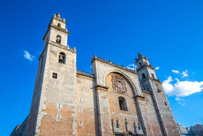 Low angle view of historic building against blue sky