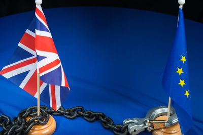 Close-up of flags with chain and lock on table