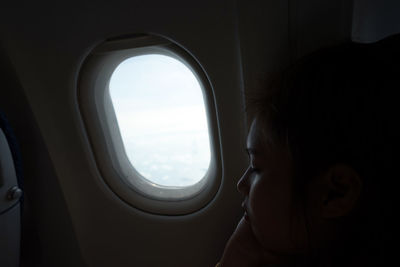 Close-up of woman sitting in airplane