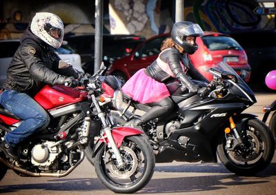 People riding motorcycle on street in city