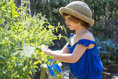 Midsection of woman standing by plants