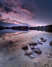 Scenic view of lake against sky during sunset