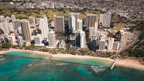 High angle view of swimming pool by buildings in city