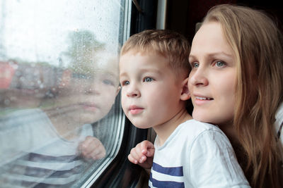 Mother and son sitting in train