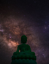 Low angle view of statue against sky at night