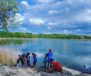 Friends standing on lakeshore