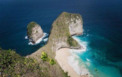 High angle view of rocks on sea shore