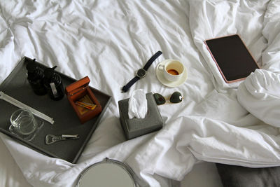 High angle view of personal accessories on bed