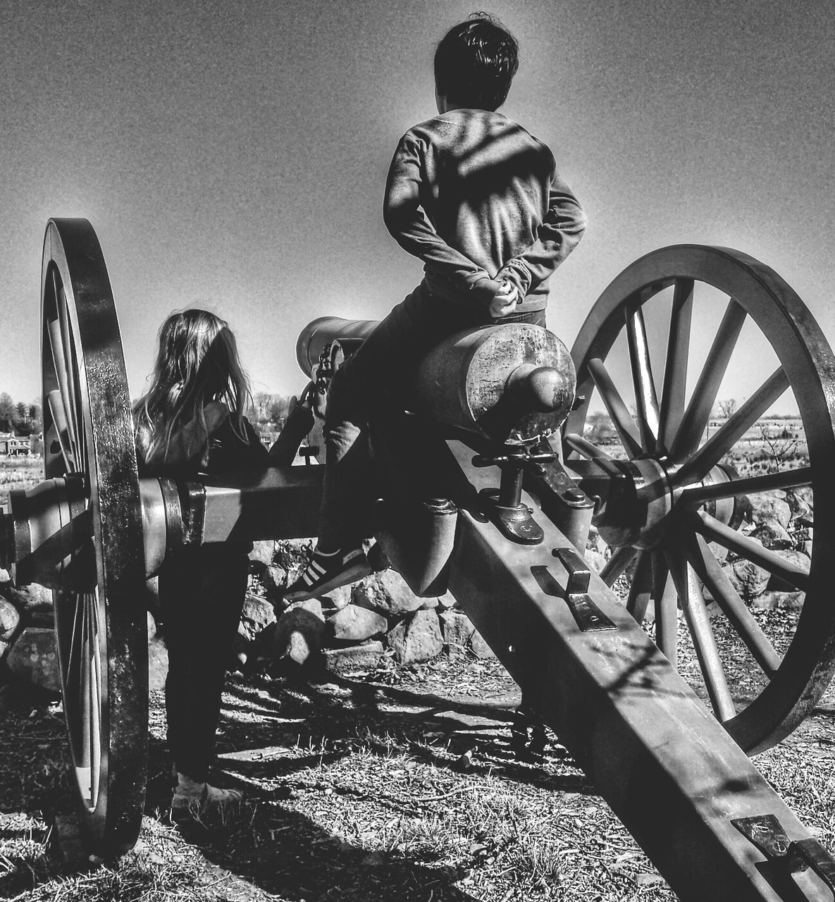 bicycle, transportation, mode of transport, land vehicle, wheel, sky, stationary, outdoors, parking, sunlight, day, travel, leisure activity, clear sky, incidental people, built structure, amusement park, street