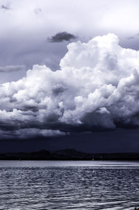 Scenic view of sea against storm clouds
