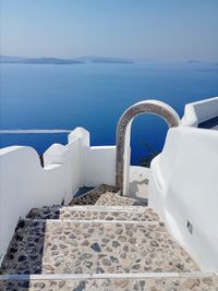 Scenic view of stairway, arch and sea against sky