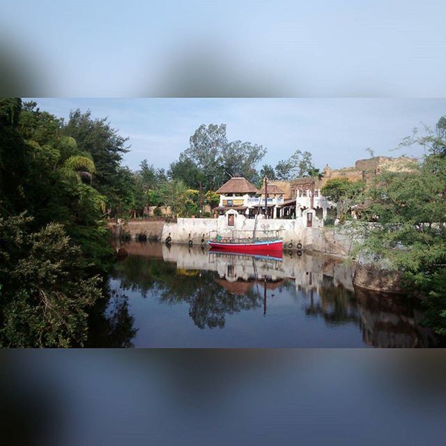 water, nautical vessel, sea, boat, tranquil scene, transportation, tranquility, mode of transport, horizon over water, sky, tree, moored, nature, scenics, waterfront, beauty in nature, clear sky, day, reflection, calm