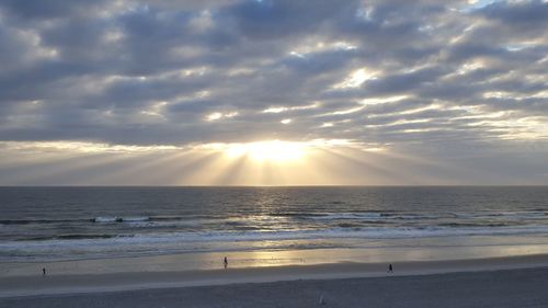 Scenic view of beach against sky during sunset