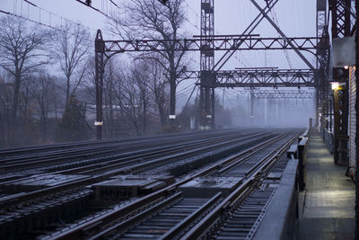 Railway tracks along bare trees