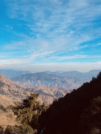 Blue sky with golden picturesque clouds and mountains