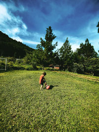 A boy who was running and playing football in a beautiful grass garden