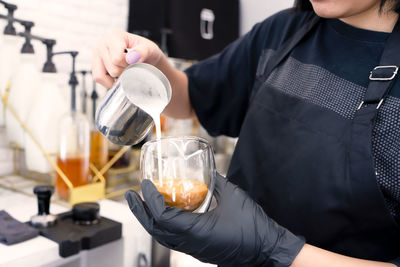 Midsection of man working in glass