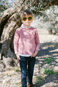 Portrait of boy wearing sunglasses in forest