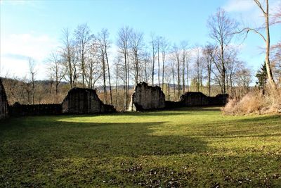 Built structure by trees against sky