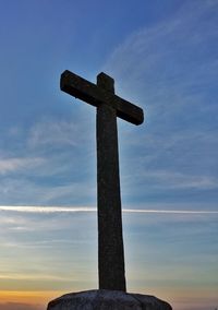 Low angle view of cross against sky