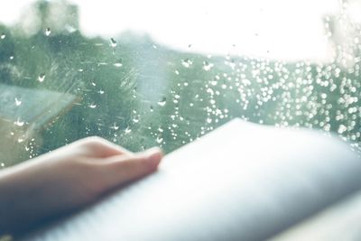 Close-up of person hand over water