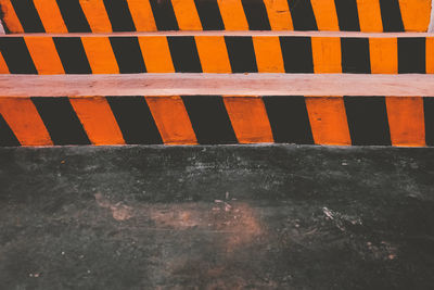 High angle view of railing against orange wall