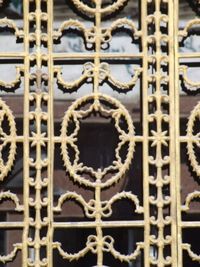 Close-up of metal gate against building