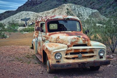 Abandoned car on field
