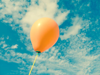 Low angle view of balloons against sky