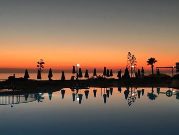 Silhouette men against clear sky during sunset