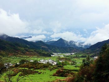 Scenic view of mountains against cloudy sky