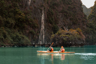 People canoeing on river