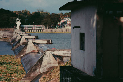 Houses on shore against sky