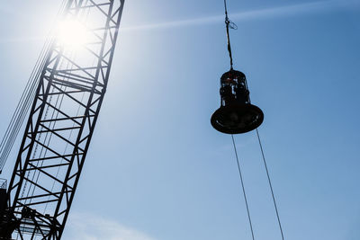 Low angle view of communications tower against blue sky