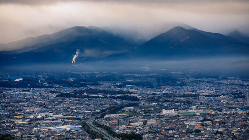 High angle view of city against cloudy sky