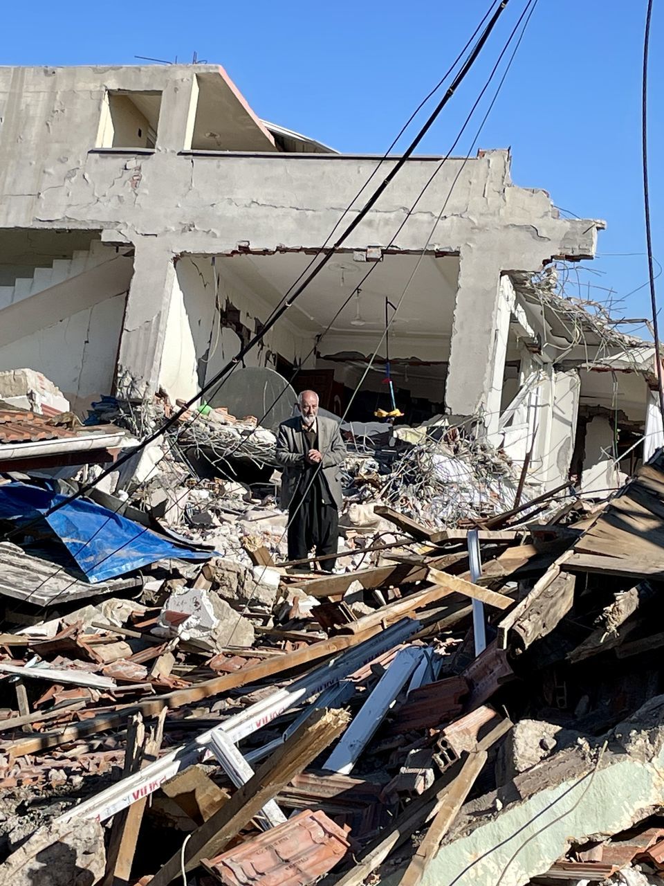 earthquake, architecture, nature, day, sky, demolition, damaged, transportation, built structure, no people, nautical vessel, sunlight, abandoned, destruction, outdoors, ruined, mode of transportation, demolished, water, building exterior, building, broken, rundown, collapsing, clear sky, blue, vehicle