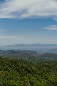Scenic view of green landscape against blue sky