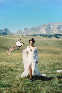 Rear view of woman standing on field