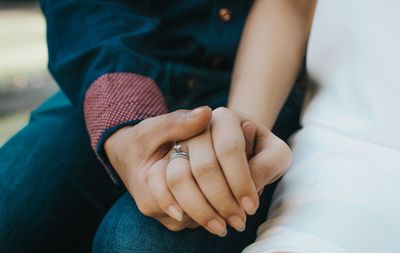 Midsection of woman holding hands