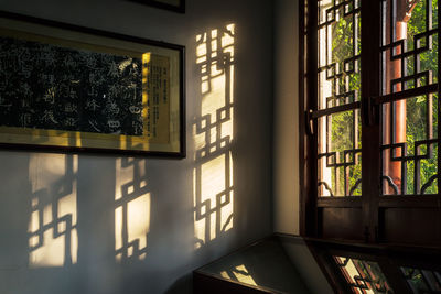 Close-up of glass window on table against building