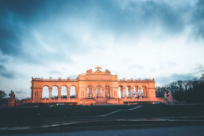 Low angle view of schonbrunn palace garden gloriette against cloudy sky