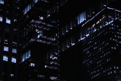 Low angle view of illuminated buildings in city at night