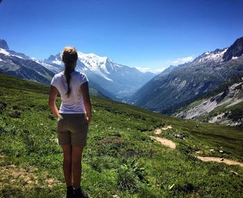 Woman on landscape against mountains