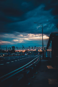 City street against sky at dusk